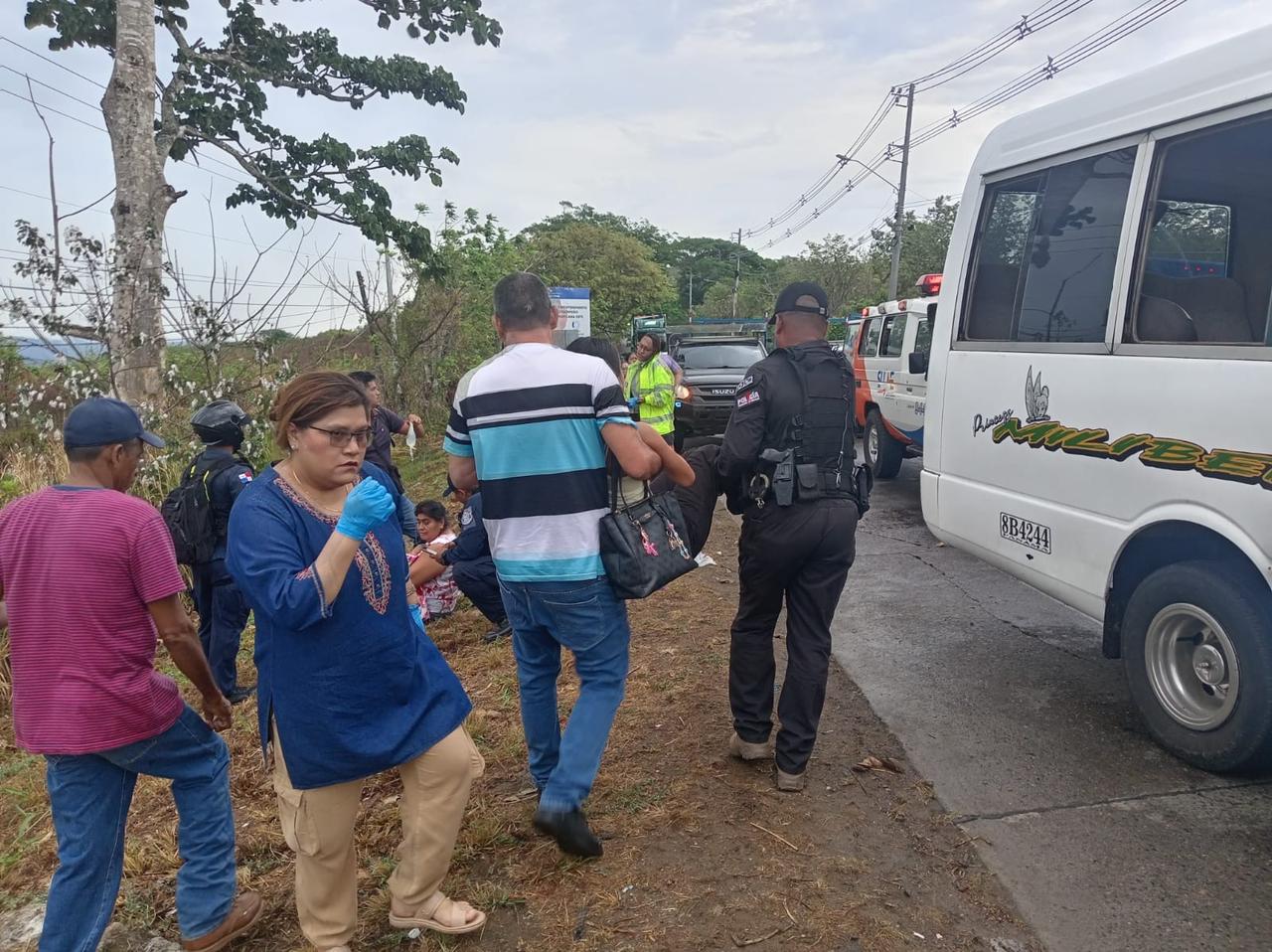 Emergency responders assisting injured people near a crashed minibus and truck on a road in Pacora, Panama