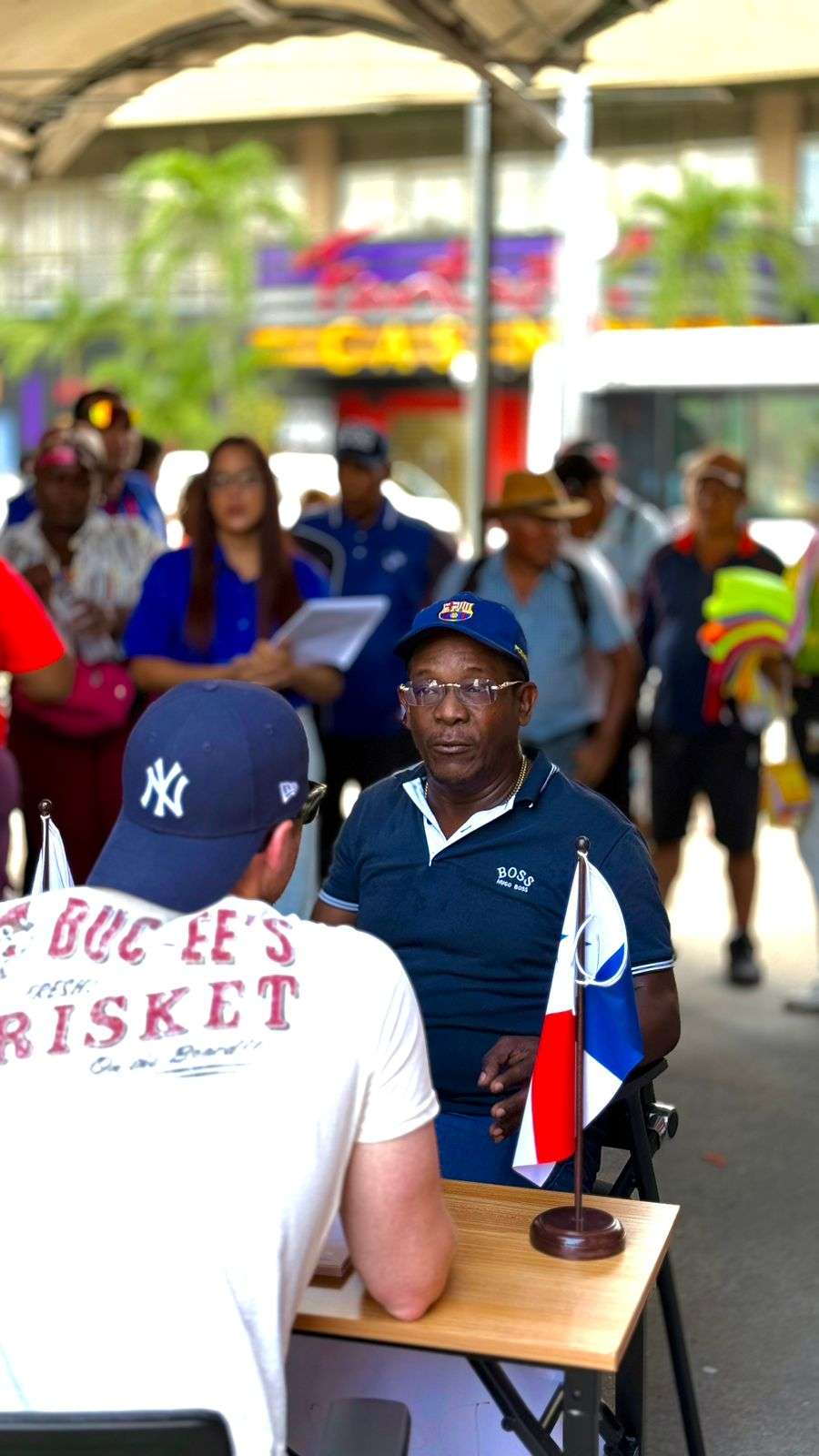 Panama City mayor Mayer Mizrachi speaking with microentrepreneurs inside Mercado El Cruce during a market visit
