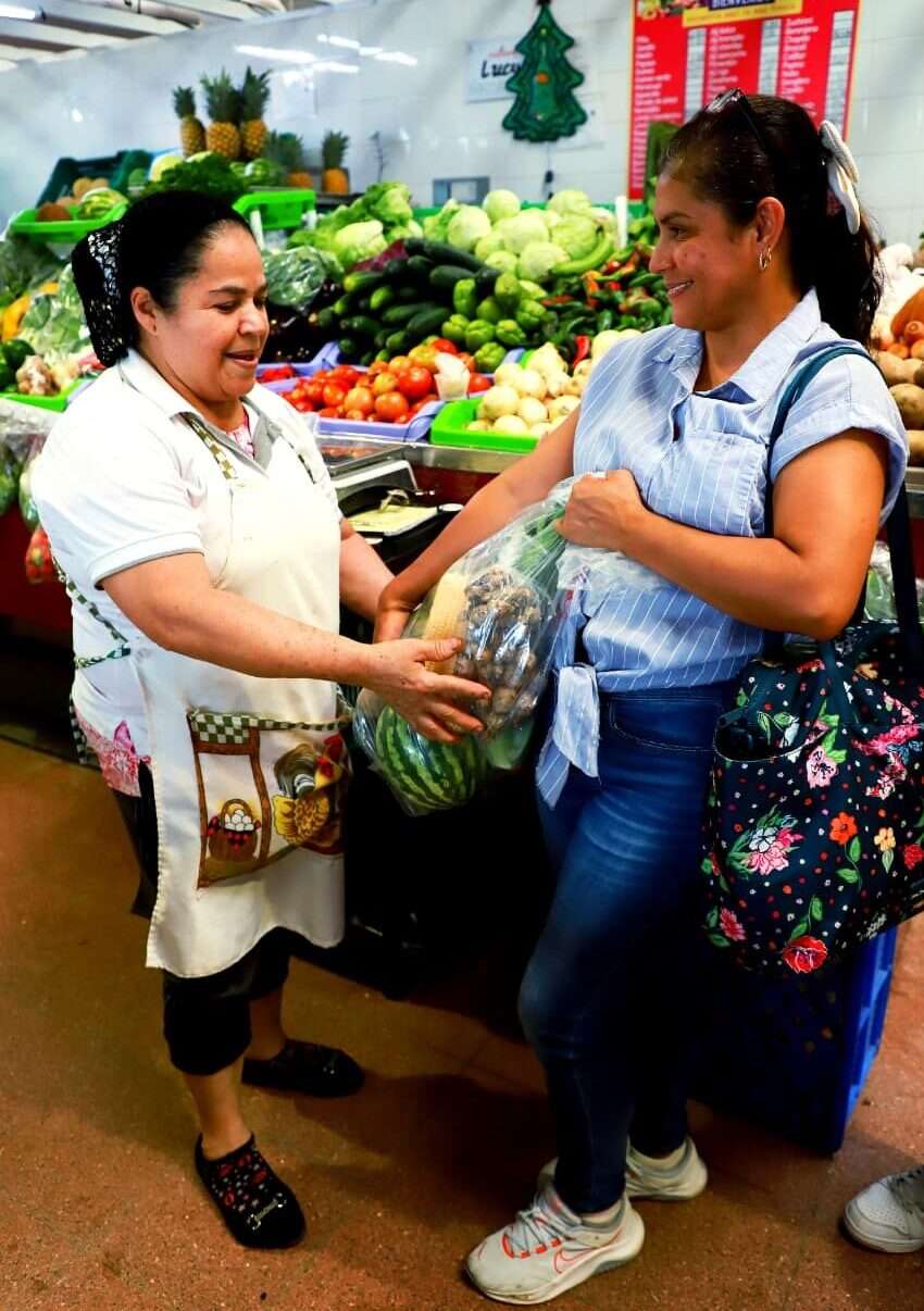 Vendors displaying bags of fresh vegetables and fruit at Mercado San Felipe Neri in Panama City
