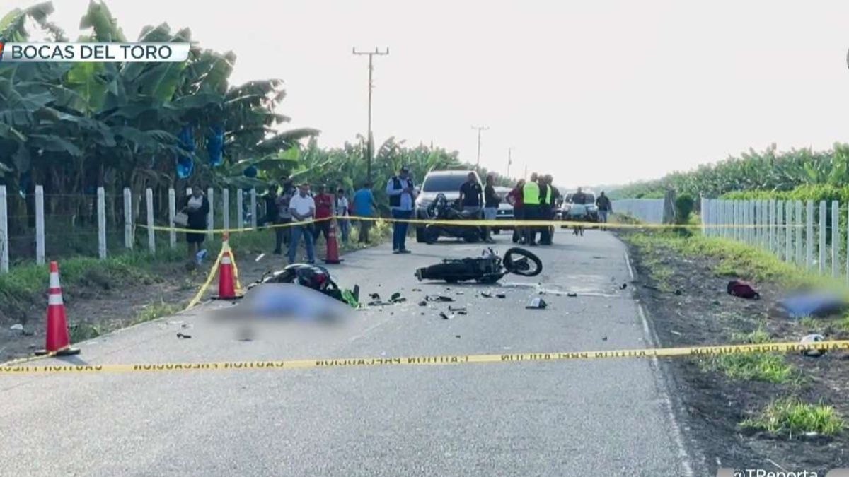 Police or emergency responders near a motorcycle crash scene on a road in Bocas del Toro