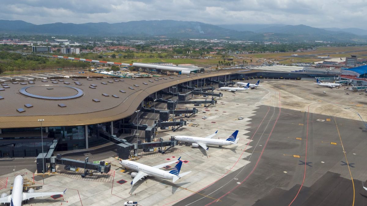 Aircraft on a runway at Tocumen International Airport in Panama with airport operations in the background