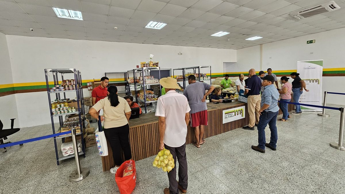 Shoppers at a small government-run village store in La Villa de Los Santos browsing household goods
