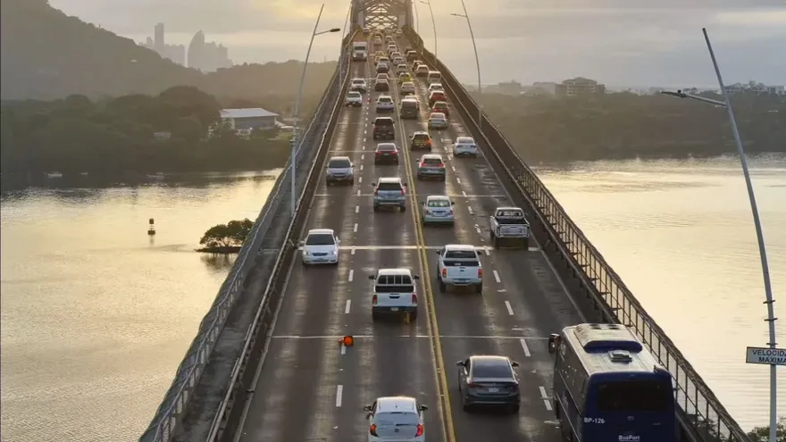 Vehicles crossing the Bridge of the Americas in Panama City during an afternoon traffic change
