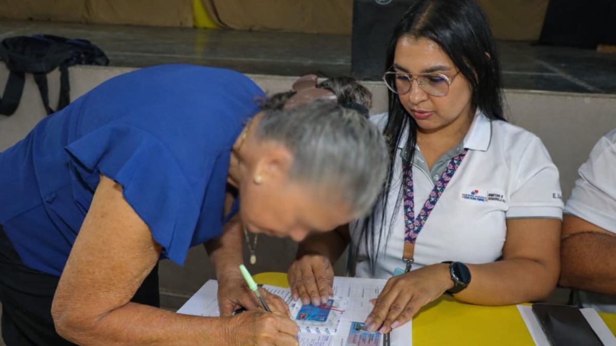Government officials reviewing beneficiary records alongside vehicle registration data in Panama