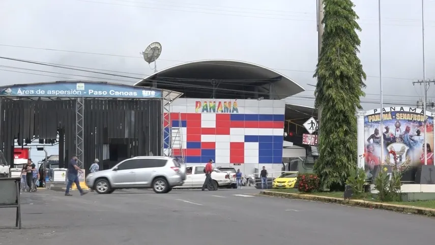 Border officials and a crossing checkpoint at Paso Canoas between Panama and Costa Rica with vehicles and security infrastructure