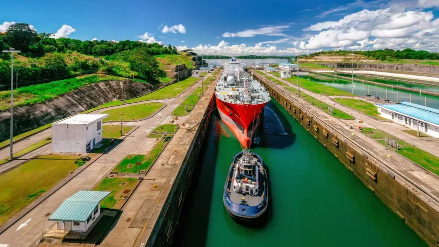 Panama Canal operations with a vessel passing through a lock and canal workers nearby