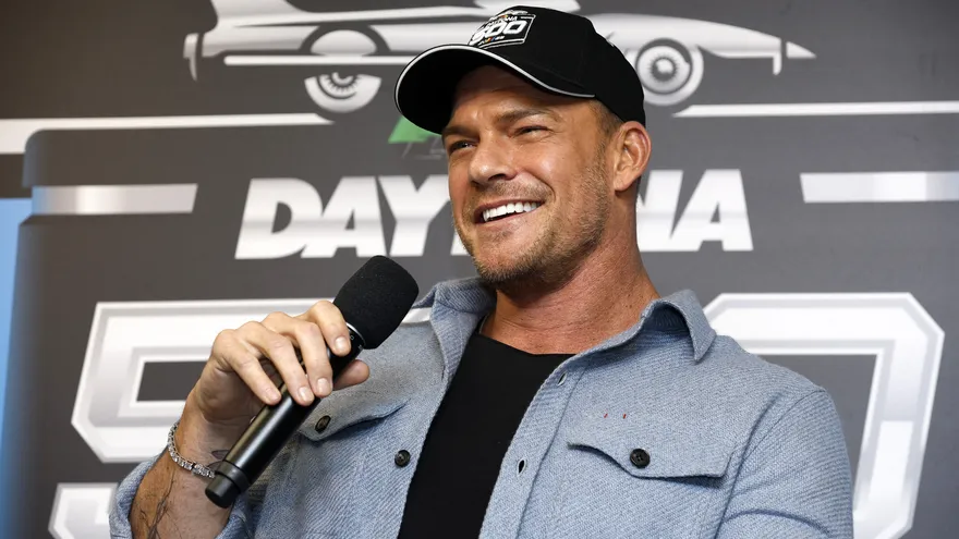 Actor Alan Ritchson appearing outdoors in a tropical setting, reacting to Panama's intense heat