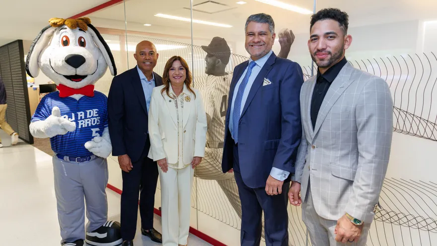 Young baseball players in Panama taking part in a youth skills competition with coaches and MLB branding in the background