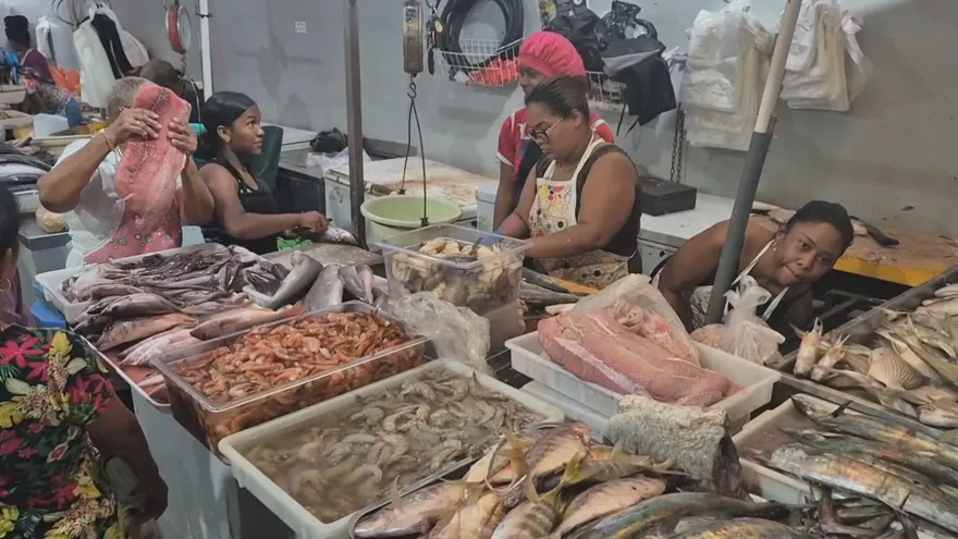 Shoppers buying fish and other seafood at a market in Colón during Holy Week preparations