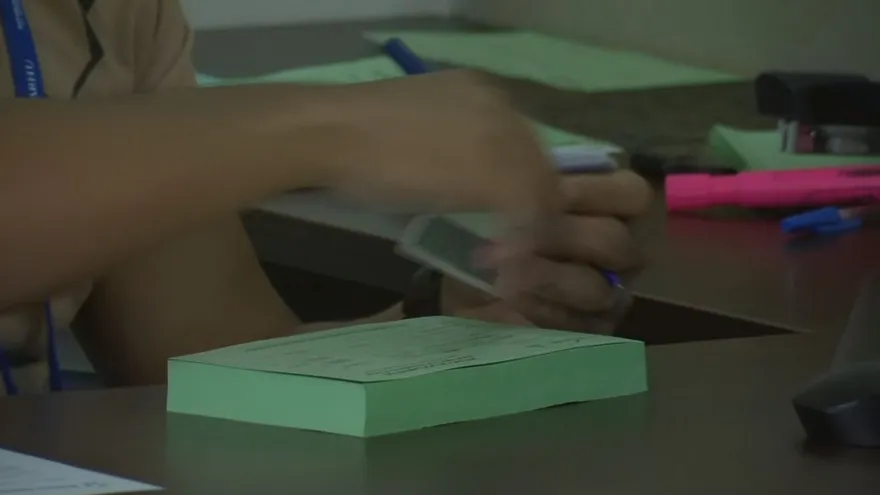 An IFARHU office building in Panama City with a government emblem and people walking nearby
