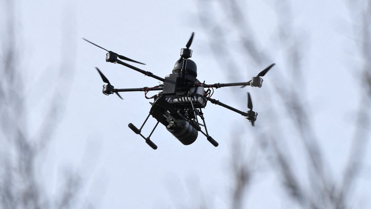 Japanese and Russian flags with a drone silhouette over a map of Ukraine