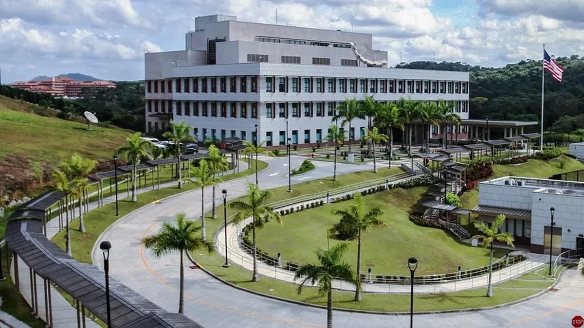 People browsing tables of secondhand household items at a yard sale in Panama