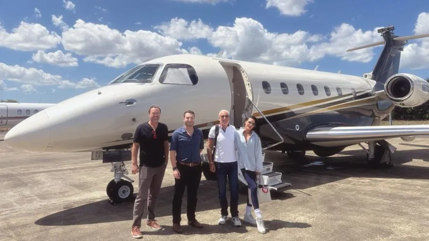 Peter Schiff speaking at a financial event, with Panama’s skyline or map in the background