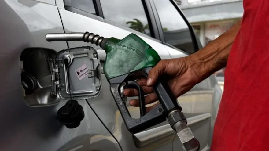 Fuel pumps at a service station in Panama with drivers and transport vehicles nearby