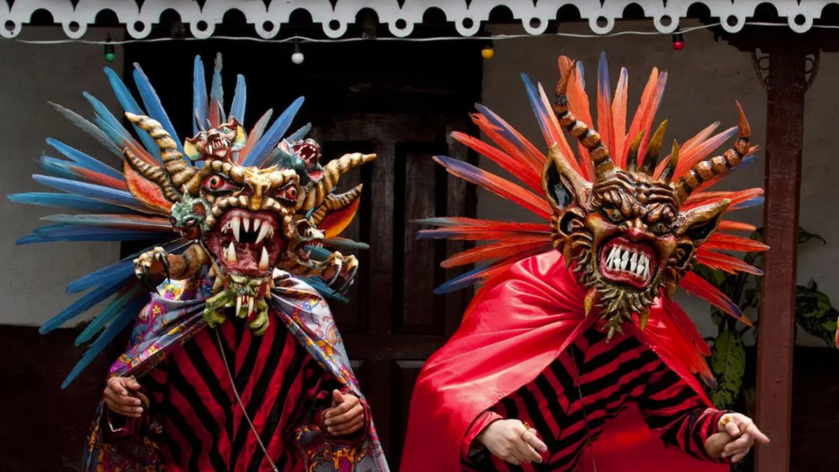 Dancers in colorful devil costumes performing at a traditional folkloric festival in Panama