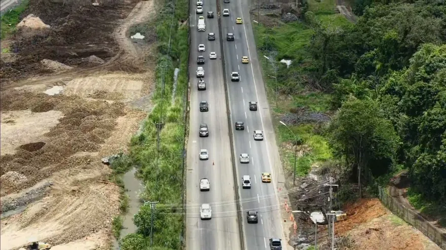 Vehicles traveling on a Panamanian highway with traffic officers managing lane inversion during Holy Week