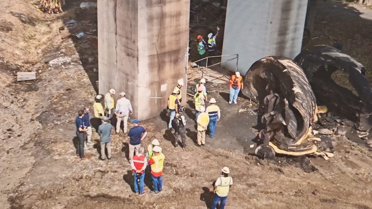 Engineers inspecting the Bridge of the Americas spanning the Panama Canal after a fire
