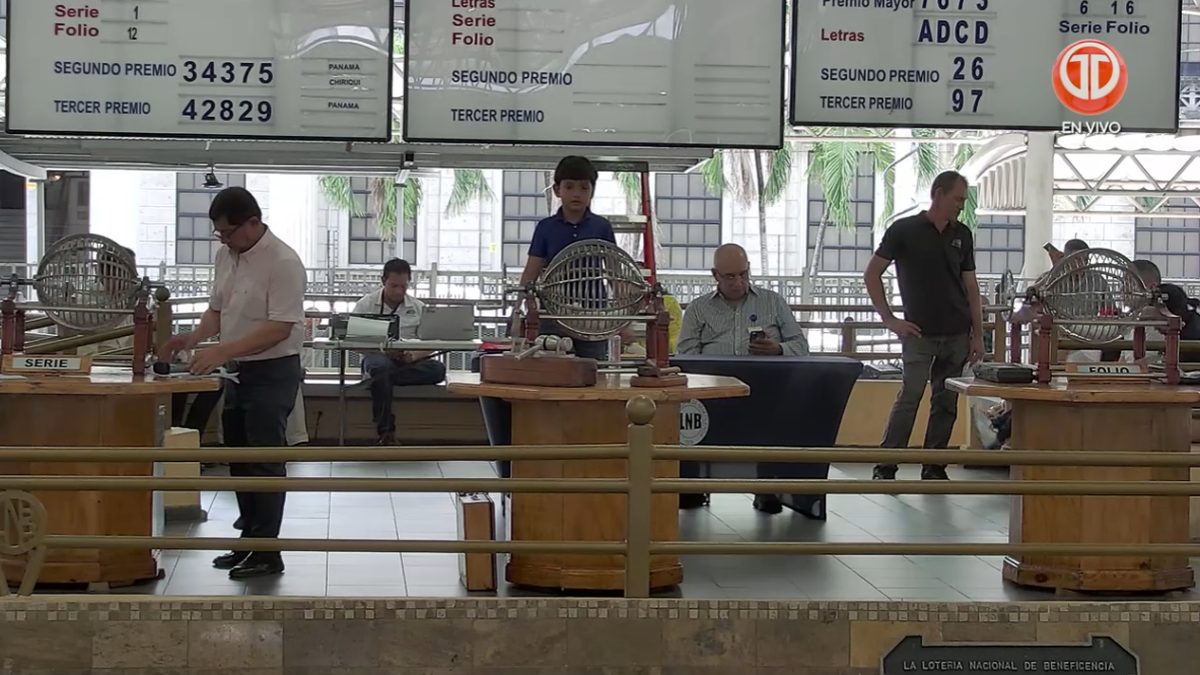 People checking the results of Panama's national Wednesday lottery draw on a phone or printed ticket