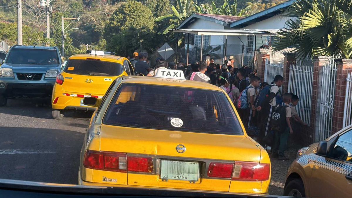 Parents and school staff outside a school entrance in Pedregal discussing safety concerns after an attempted robbery