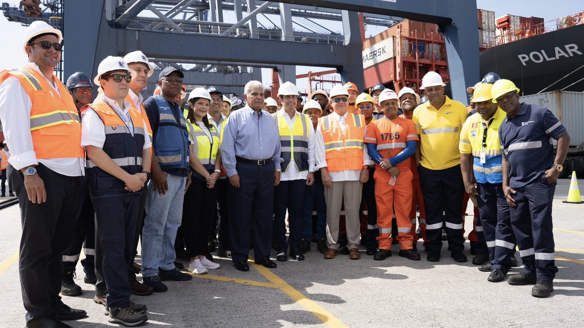 President Mulino touring operations at Balboa Port with port workers and maritime equipment in the background