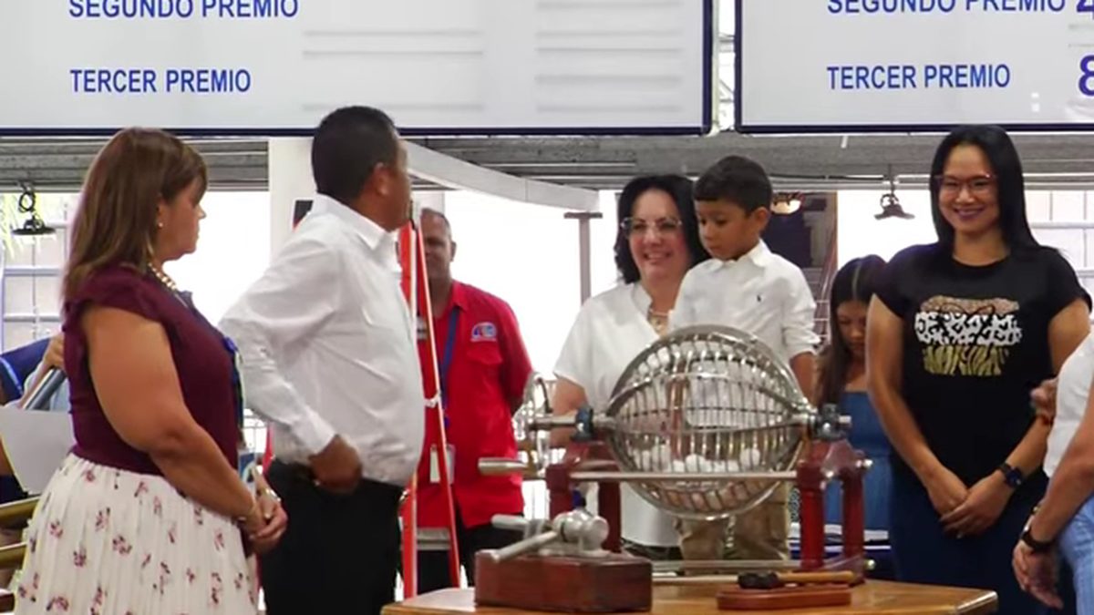 A lottery drawing setup with numbered balls and a broadcast screen in Panama