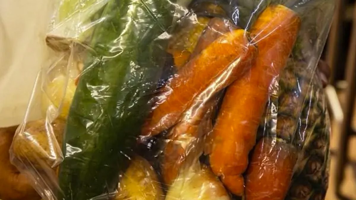 Shoppers at the San Felipe Neri Market browsing pork and other food items during a special market sale