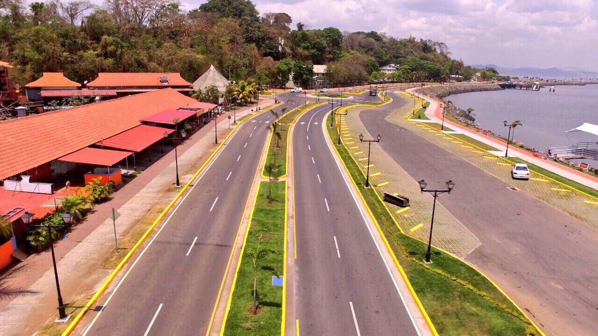 People walking along the Amador Causeway in Panama City near waterfront shops and pedestrian areas