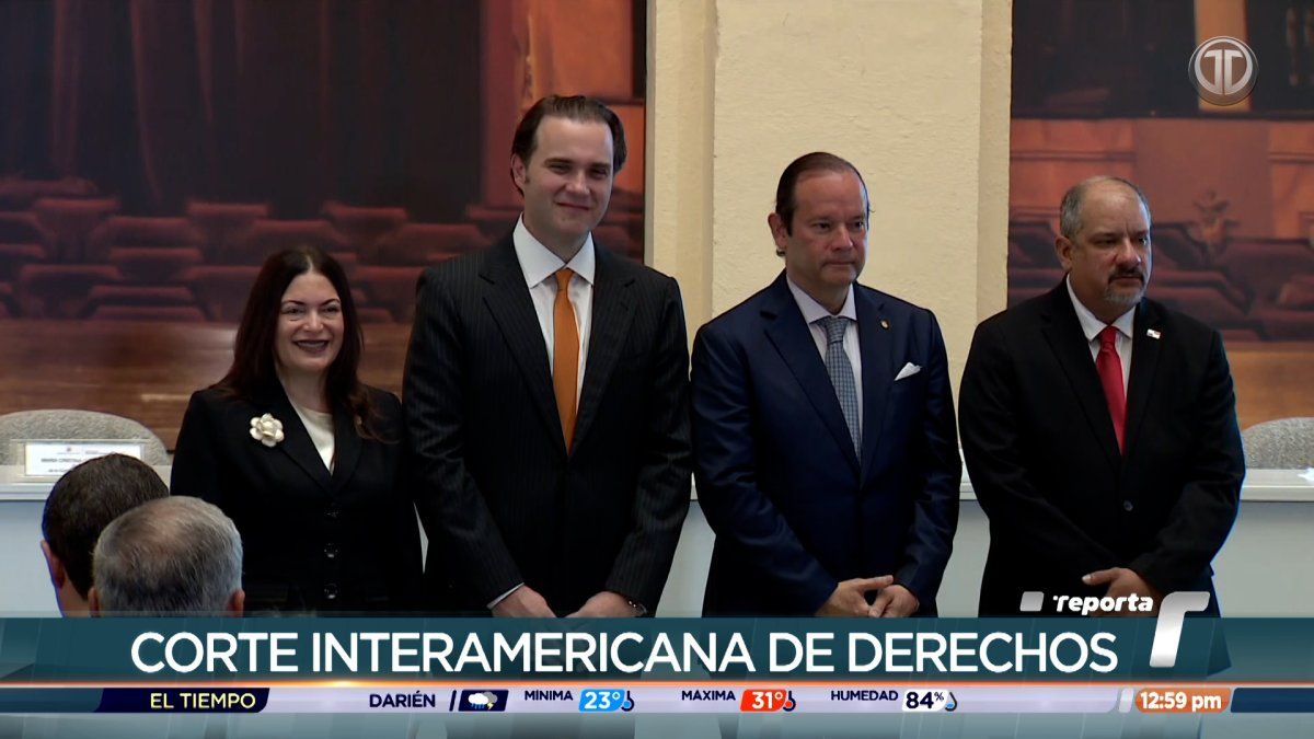 Officials at a formal human rights court session in Panama with national and institutional flags in the background
