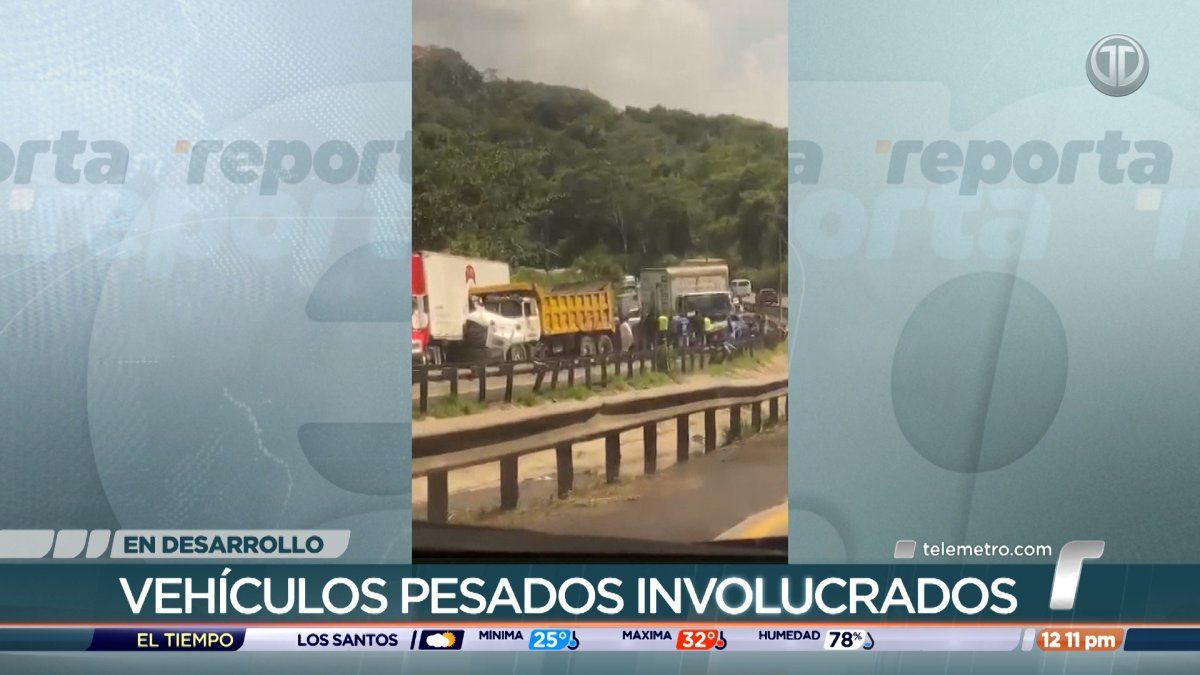 Traffic backed up on a busy Panamanian highway near a bridge after a multi-vehicle crash involving trucks and cars