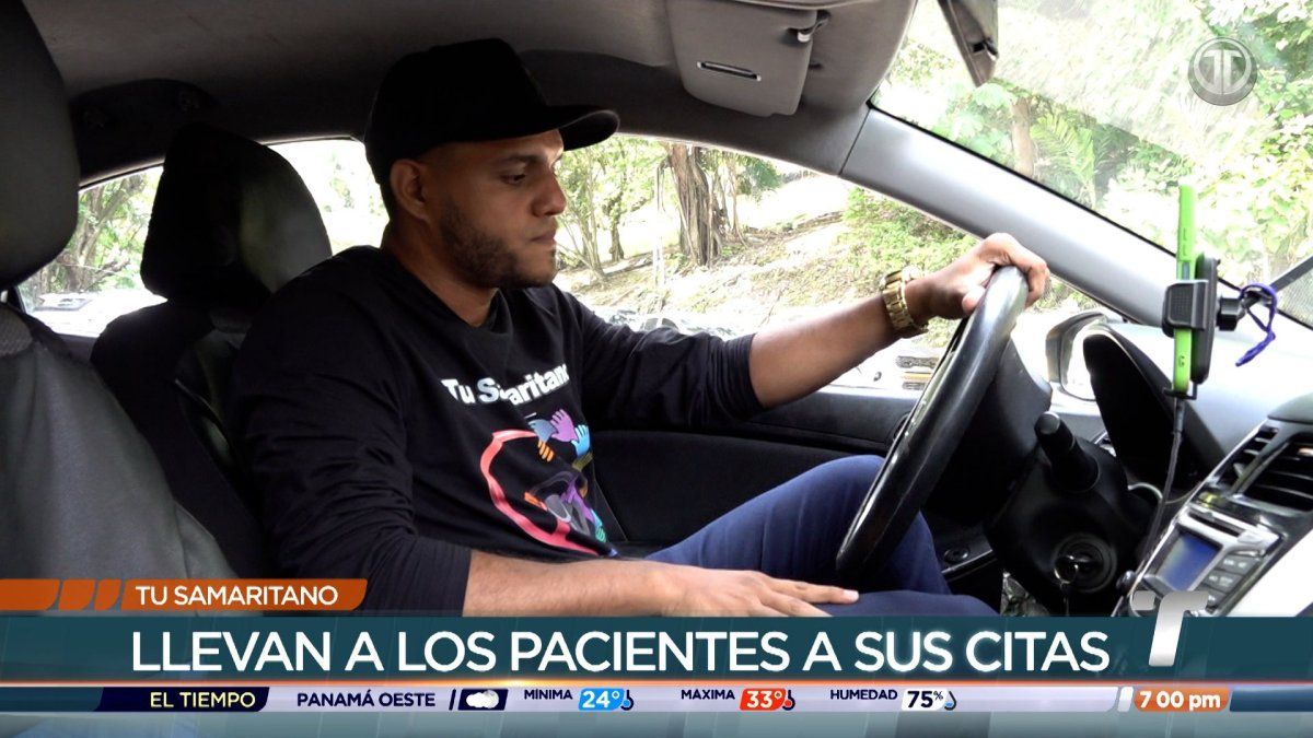 A volunteer driver helping a cancer patient into a car for a free ride to the National Oncology Institute in Panama