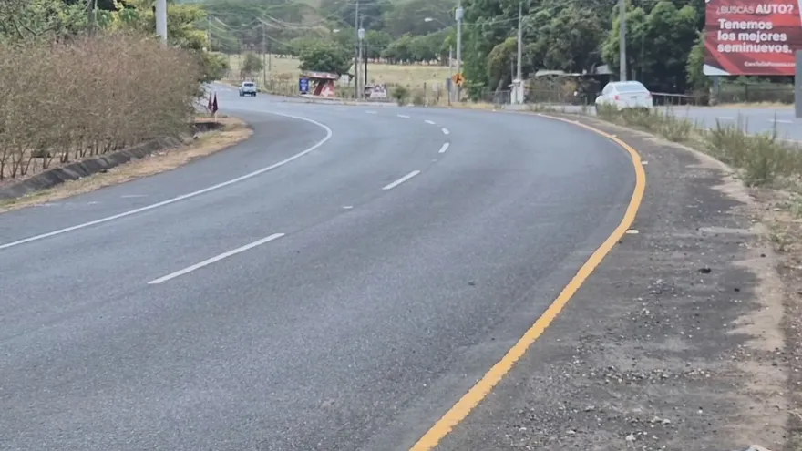 A dangerous curved roadway in rural Los Santos, Panama, where drivers are urged to slow down after a fatal crash.