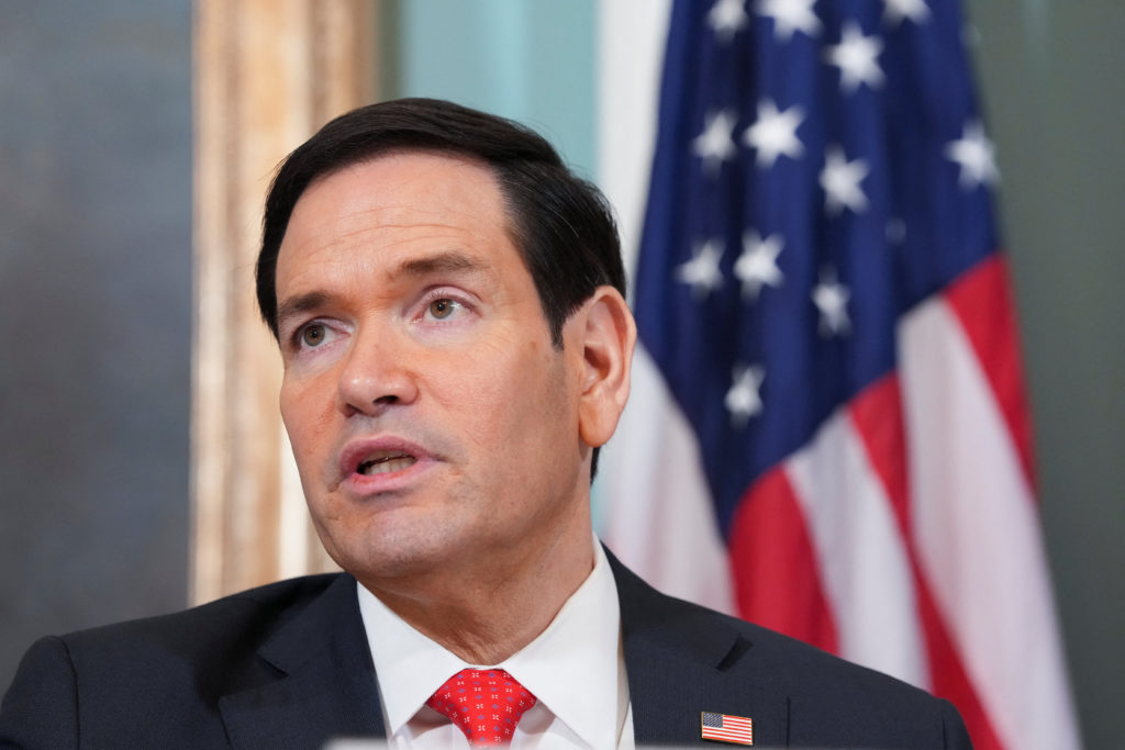 Secretary of State Marco Rubio walking toward a diplomatic meeting in Rome or Vatican City