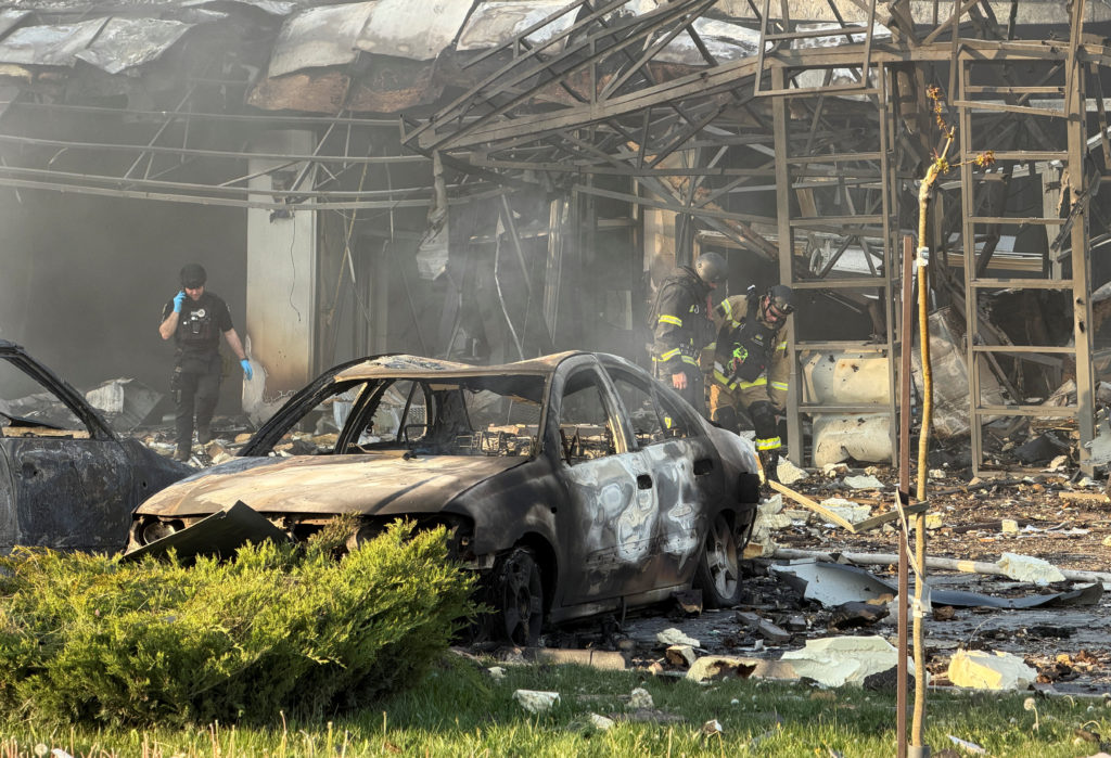 Smoke rising over a damaged building in a Ukrainian city after a Russian airstrike