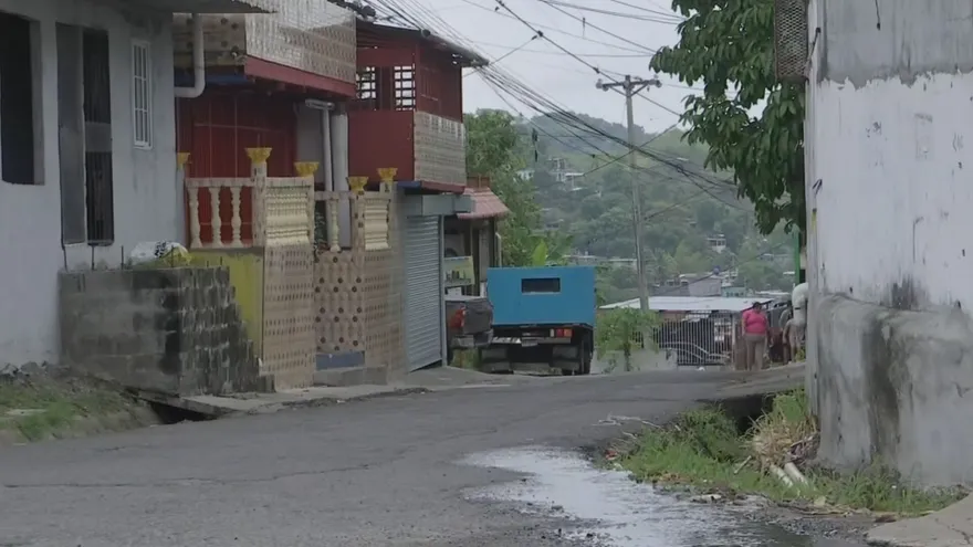 Residents walking through a neighborhood street in San Miguelito as a curfew begins in Belisario Frías and Arnulfo Arias