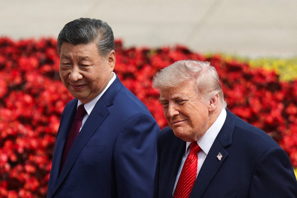 Xi Jinping and President Trump meeting in Beijing with national flags in the background