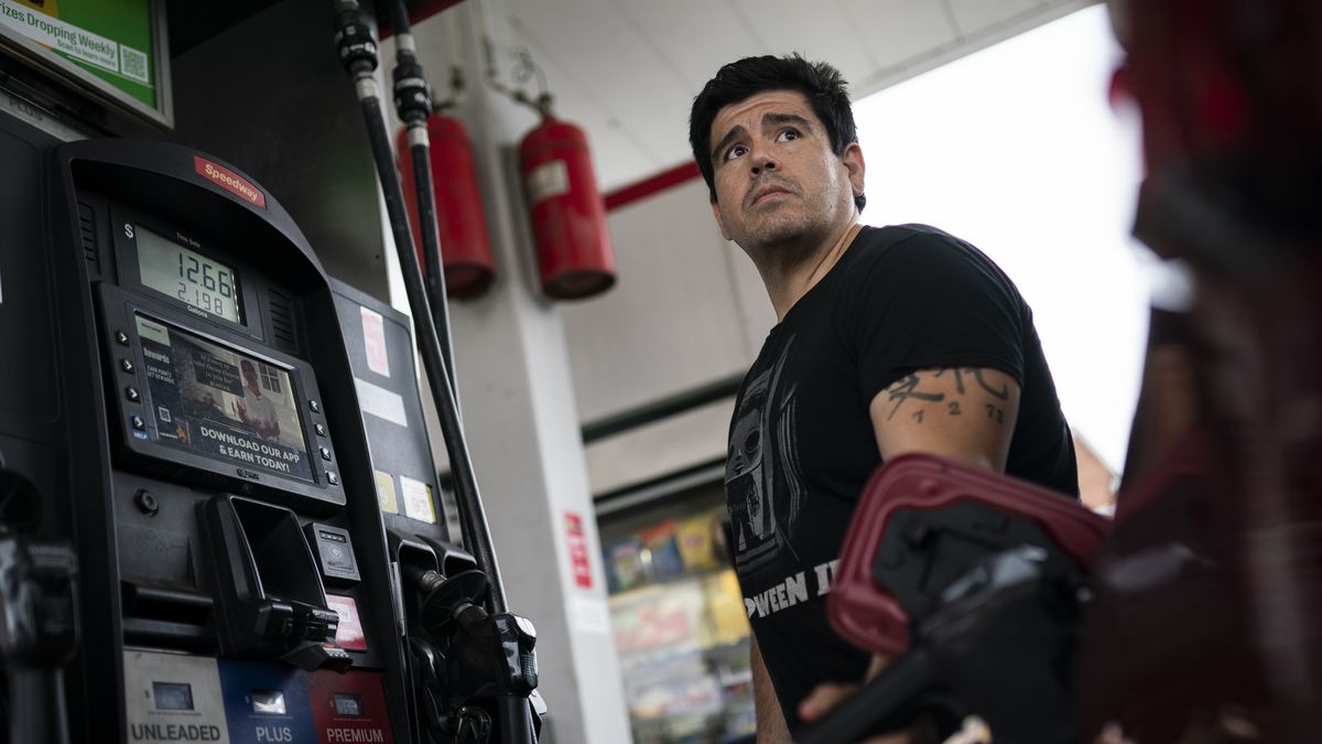 A driver refueling a car at a gas station in Panama as fuel prices are adjusted