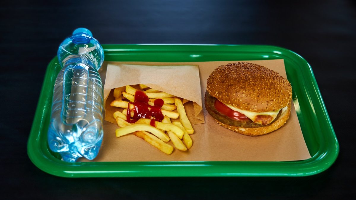 Fast-food combo meal with a bottled water option beside soft drinks in Panama