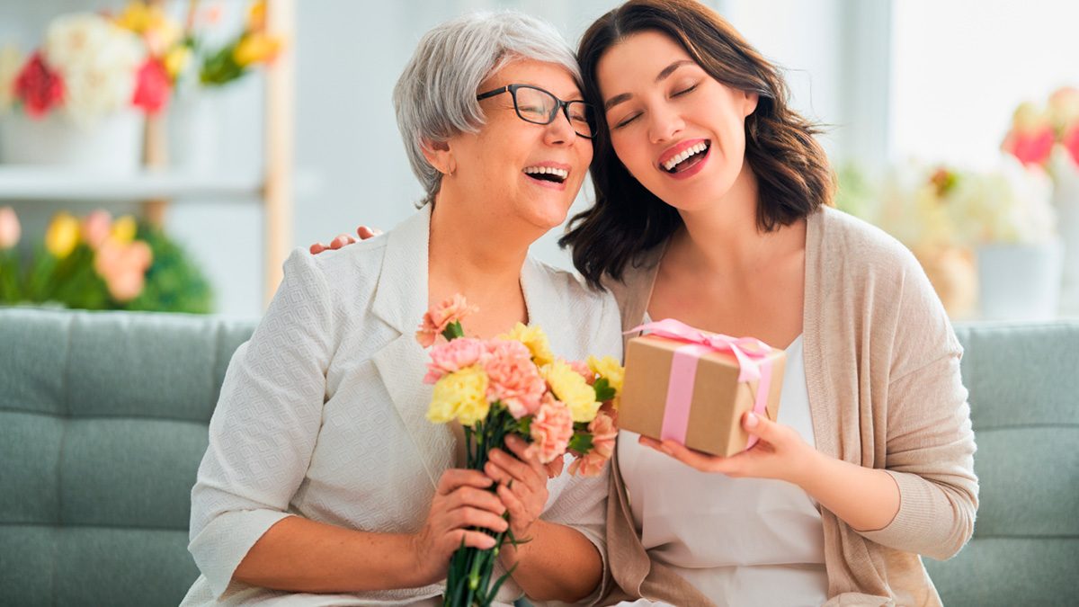 A family in Panama celebrating Mother’s Day with flowers and a small gathering at home